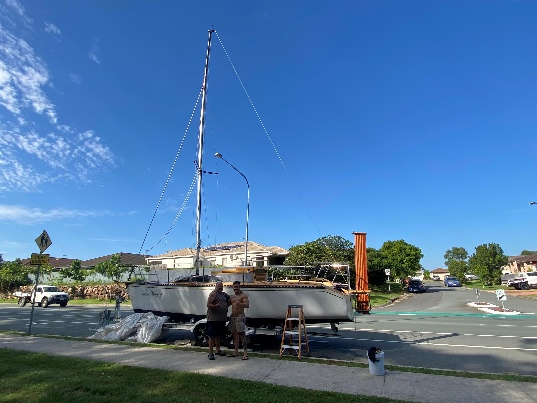 A group of people standing next to a sailboat AI-generated content may be incorrect.