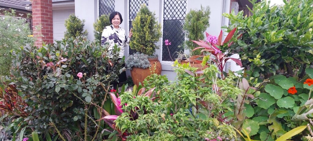 A person standing in front of a garden AI-generated content may be incorrect.