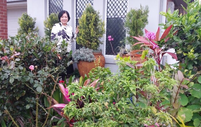 A person standing in front of a garden AI-generated content may be incorrect.