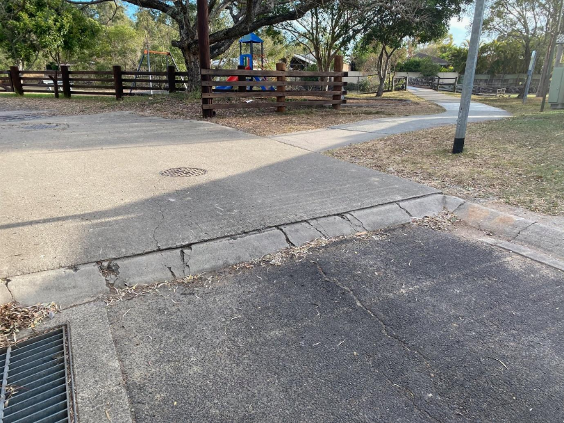 A road with a playground and a fence AI-generated content may be incorrect.