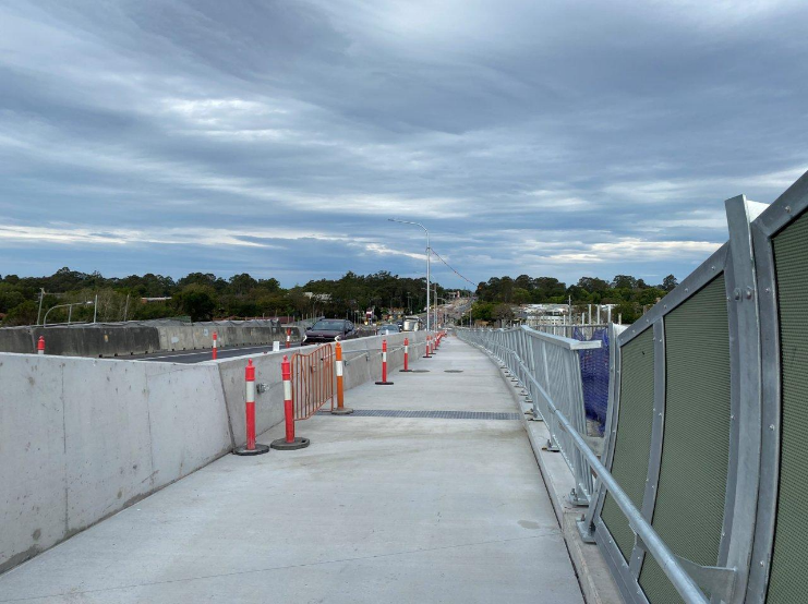 A road with orange and white cones AI-generated content may be incorrect.