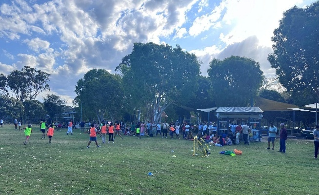 A group of people in a field AI-generated content may be incorrect.