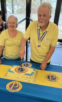 A person and person cutting a cake AI-generated content may be incorrect.