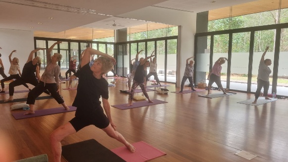 A group of people doing yoga AI-generated content may be incorrect.